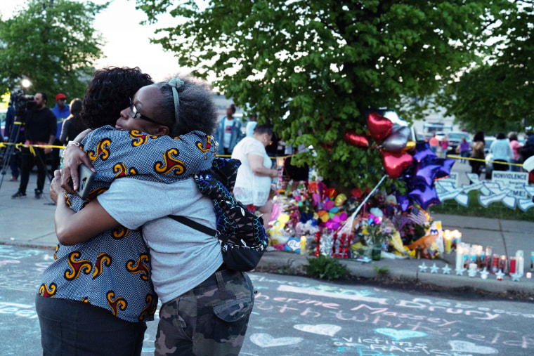 Two women embrace each other during the community vigil for the victims of the shooting in Buffalo, N.Y., on Sunday.